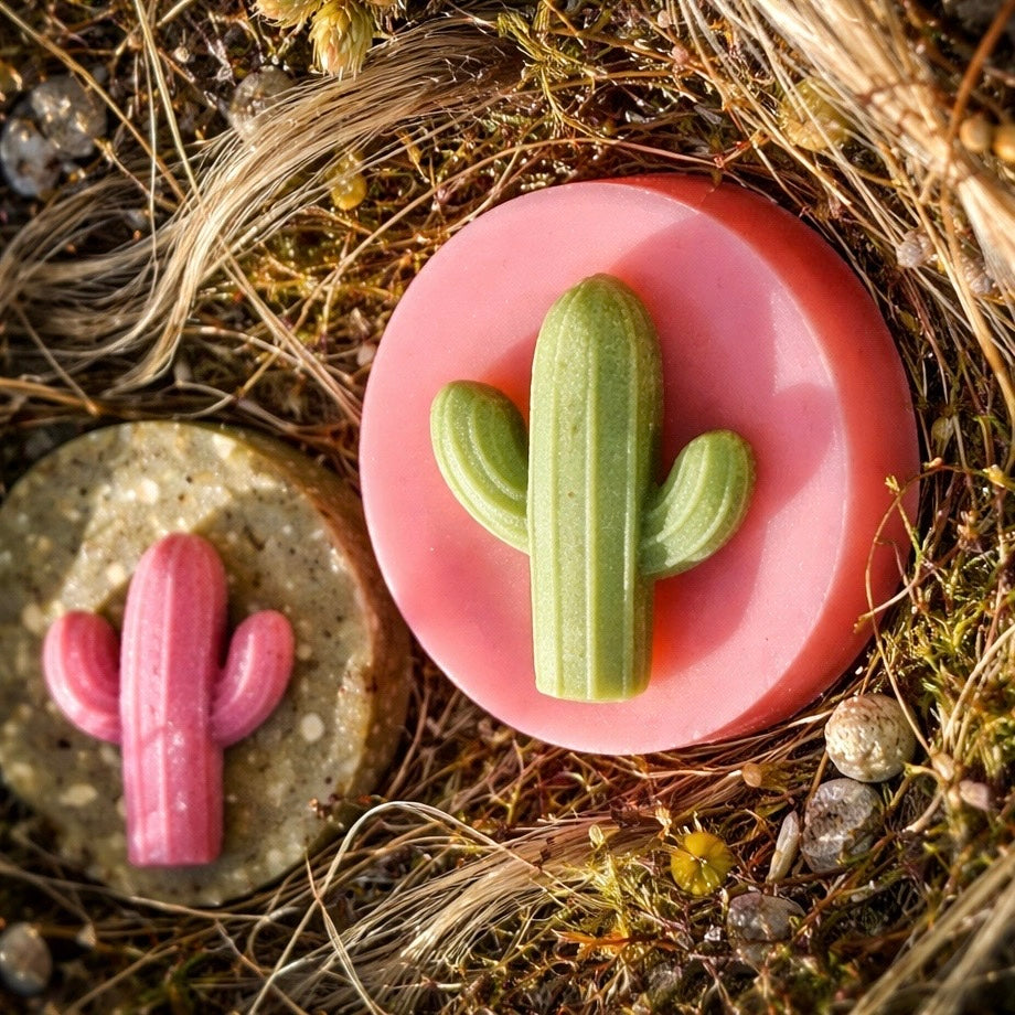 Two cactus-shaped soap bars on a natural background